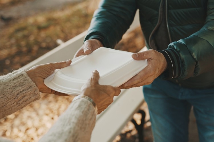 Food being handed from one person to another.