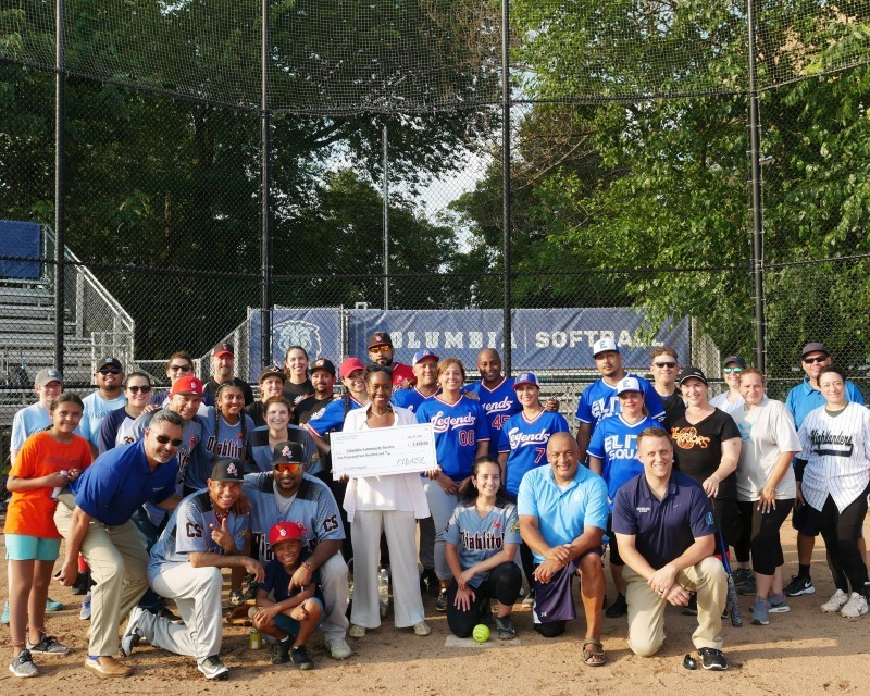 Several members of the Columbia staff softball league pose with Christa Hill of Columbia Community Service and Ross Frommer of the Medical Center Neighborhood Fund, both holding the checks presented for charity. Teams shown include Big League Chews: Undergrad Student Life; Da’ Bunts: Office of Alumni and Development; Elite Squad: Materials Management at NYP; Legends: Columbia Psychiatry; MVP Builders: Manhattanville Development Group; Silverbacks: CUIT; Warriors: Endoscopy Suite (NYP); Highlanders: CUIMC Fa